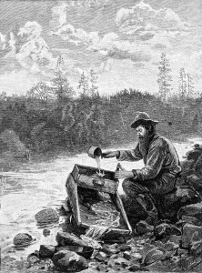 Man prospecting for gold by using a cradle.
